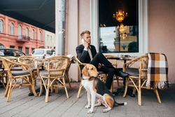 Businessman with dog in the cafe