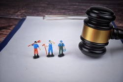 Selective focus image of gavel with miniature of labor. Labor law concept. 