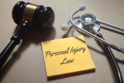 Top view image of gavel and stethoscope with Personal Injury Law wording. Law medical concept.