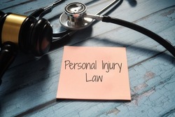 Personal Injury Law wording with stethoscope and gavel. 