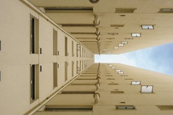windows of a building seen from below forming a symmetry