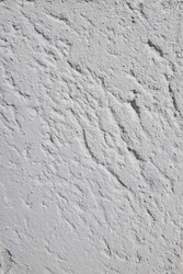 Close up on a painted wall with a rough bumpy surface, background texture