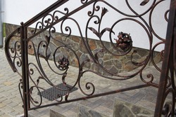 Metal railing forged,stairs to the house with metal railings with forged parts