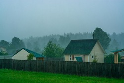 Thunderstorm with heavy rain and squall in russian village