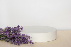 Podium for presentation on wooden table, lavender flowers. Abstract geometrical form. Cylinder stone sphere. Shadow. Scene to show products. Showcase, display case. Trendy soft shadow. Front view. 3D