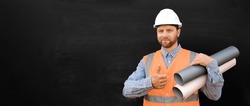 Male Engineer in a White Hard Hats, Orange West. Handsome Confident Build Worker with Blueprints Isolated on Blank Black Background. Copy Space. Industry Manufacturing Factory. Mechanic Service Work.