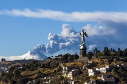 Cotopaxi volcano eruption and Panecillo's Madona seen from Quito, Ecuador