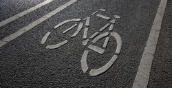 white bicycle sign on bike lane