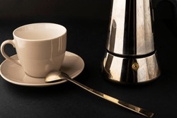 Brewed fresh coffee on a black table. Geyser coffee maker. To drink coffee
