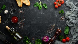 Food background. Vegetables, spices and herbs on the kitchen table. Top view. Free space for your text.