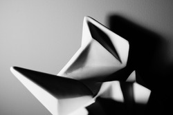 Origami shaped sculpture. Geometric background in black and white