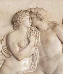 Ornamental relief of a fountain in Florence, Italy. Ancient sculpture with kissing couple. Florentine art 16th Cent.