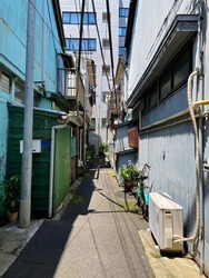 Nostalgic back alley of Japanese old folk houses behind a new building