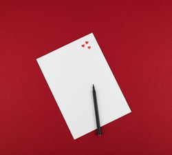 felt pen and red hearts on white paper for valentine letter