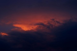 Sunset. Dark orange sky and clouds.