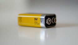 Close up 9 volt battery. White background.