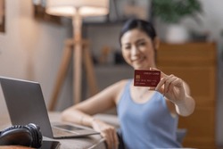 Women holding credit card and using laptop at home.Online shopping, internet banking, store online, payment, spending money, e-commerce payment at the store, credit card, concept