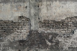 Aged scratched chipped erosion fence for 3D retro design. Cracked uneven flaked rot wall of an old castle grunge loft. Bumpy peeling dirty ruined exposed stucco on shabby medieval scary urban street