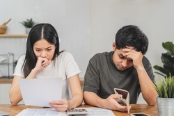 Stressed, problem, asian young couple love man, woman calculate loan, open empty wallet, purse no have money for bill payment, credit card or expense. Bankruptcy, bankrupt or debt financial, mortgage.