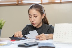 Financial owe asian woman, female sitting on floor home, stressed and confused by calculate expense from invoice or bill, have no money to pay, mortgage or loan. Debt, bankruptcy or bankrupt concept.