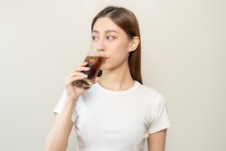 Thirsty, attractive asian young woman, girl drink or sip, holding a glass of cold sparkling water with ice in hand, refreshness people, isolated on white background. Temptation of food, health care.