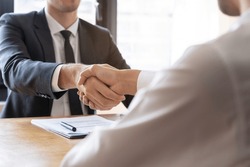 Successful asian young man, male partnership, teamwork handshake or greeting together at office after project done, good deal. Happy business people, worker or group meeting, shaking hands concept.