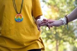 folded hands and hippie symbols