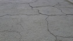 Abstract Image of a aged old wall with cracks developing on its surface, cracks in relationship concept, safety concept. cement surface painted cracked over time due to rains.