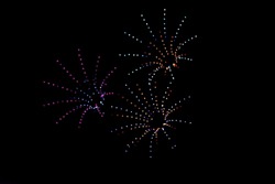 photo of colorful bokeh these drone light shows could replace fireworks on night sky background. made fireworks by drones