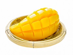 Yellow mango in a wicker basket. on a white background isolated.