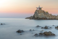 A temple on the rock island and sea