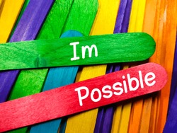 Business concept.Text Im Possible on colorful wooden stick background.