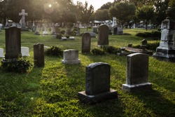 Tombstones in cemetery at dusk