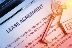 Business lease agreement concept : Pen and keychain on a lease agreement form. Lease agreement is a contract between a lessor and a lessee that allow lessee rights to use of a property owned by lessor