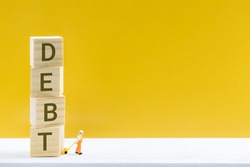 Crisis of high burden of consumer debt, financial concept : Client drags cubes of debt and find the way to escape. Debtor has difficult problem of bad debt and plan to pay back to lender or creditor.