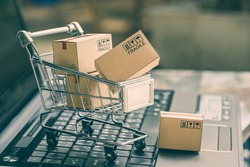 Cartons in a shopping cart on a laptop keyboard. Ideas about online shopping, online shopping is a form of electronic commerce that allows consumers to directly buy goods from a seller over internet.