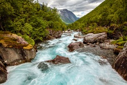 Very beautiful powerful waterfall in Norway with the effect of flowing water