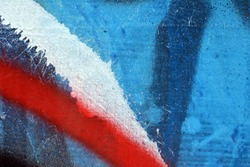Wall painted blue red white black paint. Macro photo