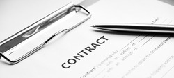 Close-up of a silver pen on docunent contract. Legal contract signing, buy sell real estate contract agreement sign on document paper with black pen
