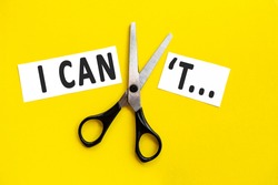 scissors cut the words i can not. concept believable. cuts the word un. I can, goal achievement, possible, potential, real overcoming. unpossible is believable.