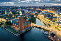 Aerial view of Stockholm city hall and illuminated cityscape at night in Stockholm, Sweden