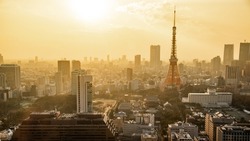 Tokyo Tower with skyline in Tokyo, Japan. Japanese landmark and modern cityscape during sunset.