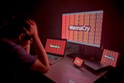 WannaCry ransomware attack on desktop screen, notebook and smartphone, cyber attack internet security concept