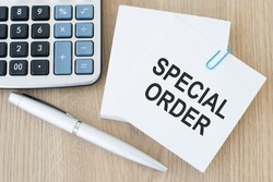 Text sign showing Special Order on card on wooden background near pen and calculator