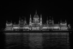 Beautiful view of the Hungarian Parliament Building at the bank of River Danube at night in Budapest, Hungary - Black and White