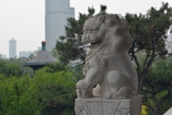 Chinese lion sculpture at a park.