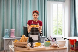 Lifestyle Young asians woman chef wearing apron and baking in home kitchen. Hobby lifestyles concept