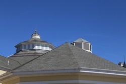 A closeup view of a slate tiled roof with octagonal roof lantern centre piece.