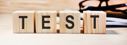 Test word made of wood background. Business concept. Test sign, exam, learning concept. Word test written with wooden cubes. Education quality control. Test background