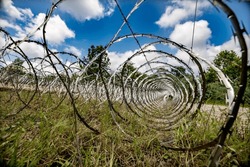 Members of the West Virginia National Guard’s 119th SAPPER Company practice concertina wire obstacle construction meant to hinder enemy advances and secure friendly forces' operational areas against